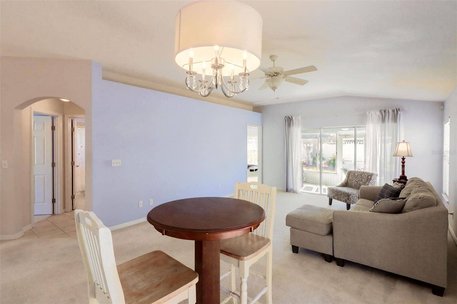 3437 GRENVILLE DRIVE, Winter Haven, FL 33884 The dining area is highlighted by vaulted ceilings and glass sliding door that leads onto the fenced-in side yard