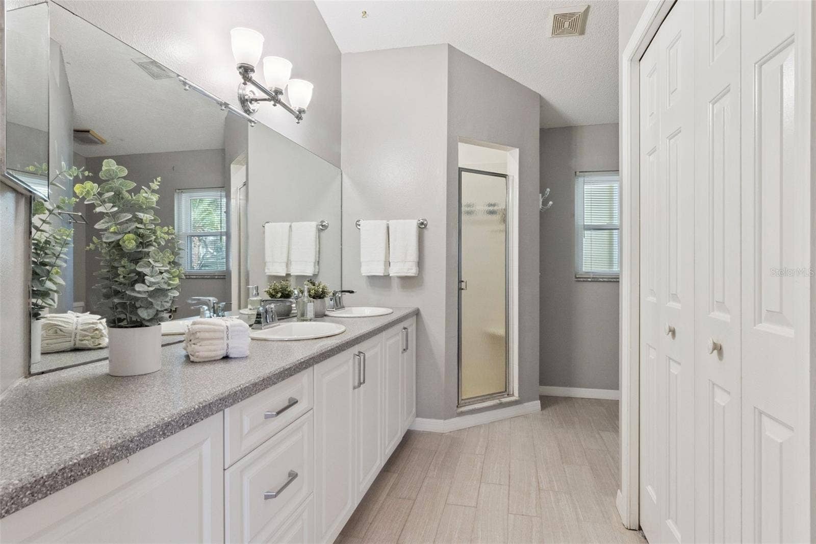 Primary Bathroom offers a Comfort Height Vanity with Dual Sinks and Walk-in Shower