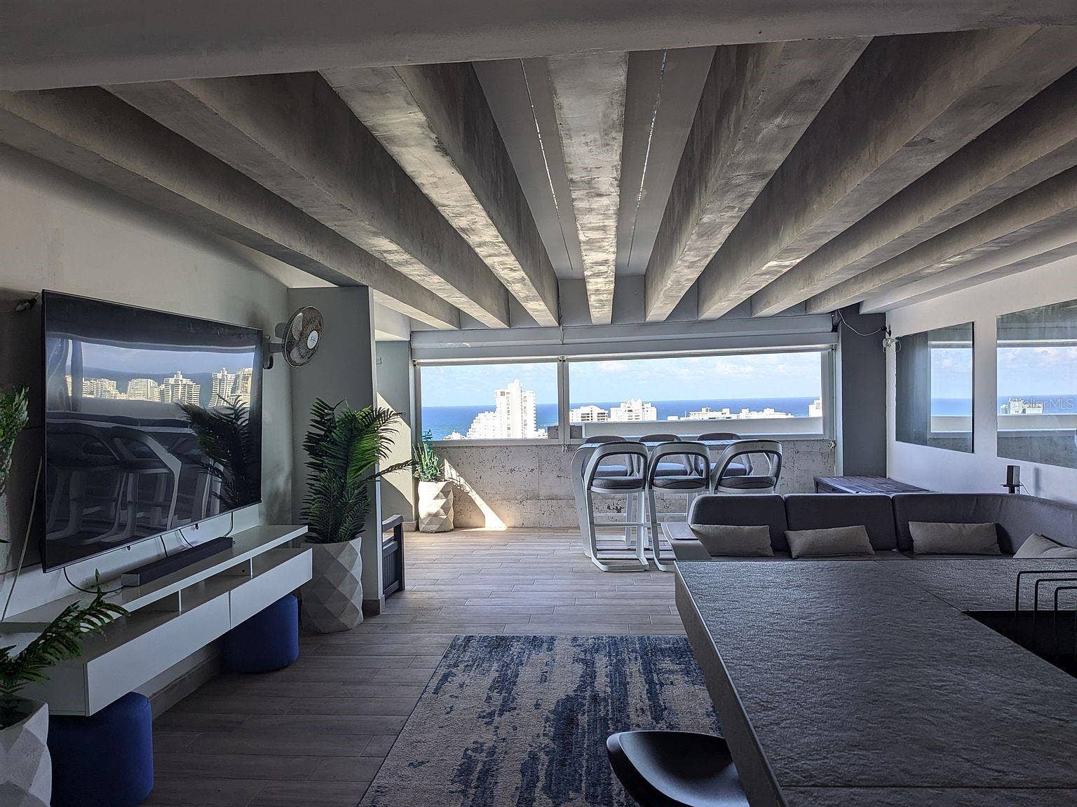 305 CALLE VILLAMIL, #PH 2001, San Juan, PR 00907 Covered terrace lounge exposed beams and ocean views