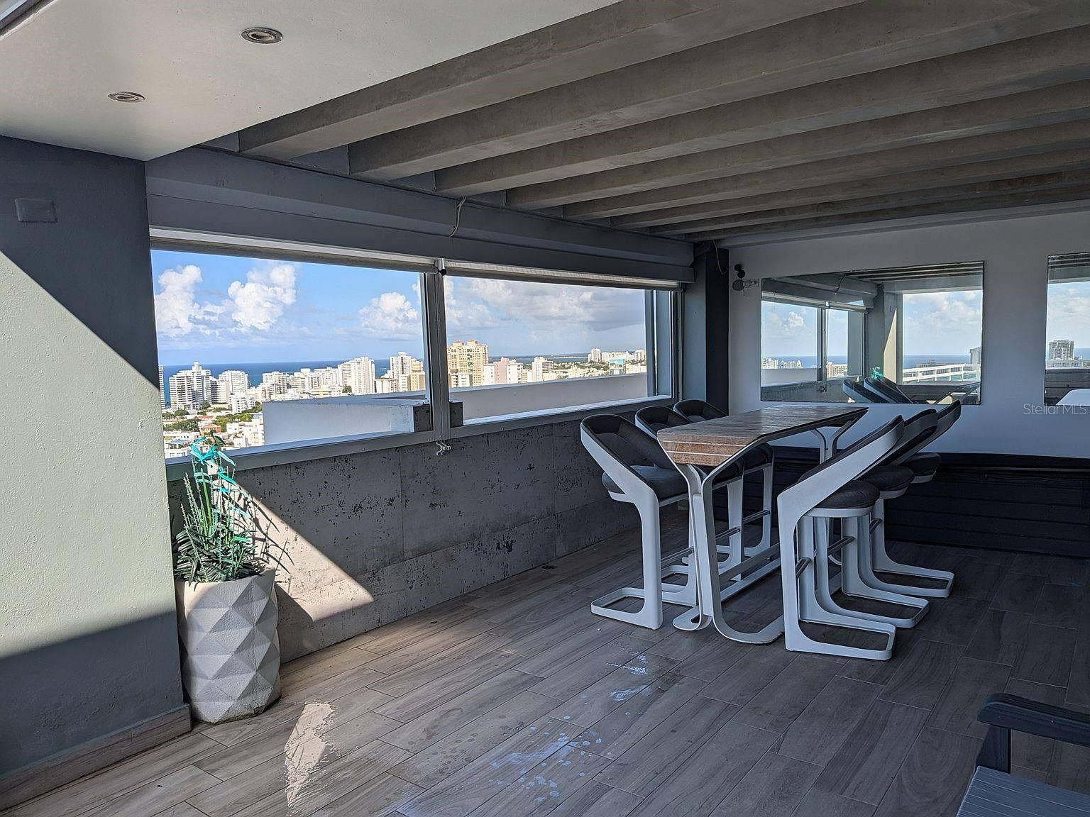 305 CALLE VILLAMIL, #PH 2001, San Juan, PR 00907 Covered terrace bar seating with city and ocean views
