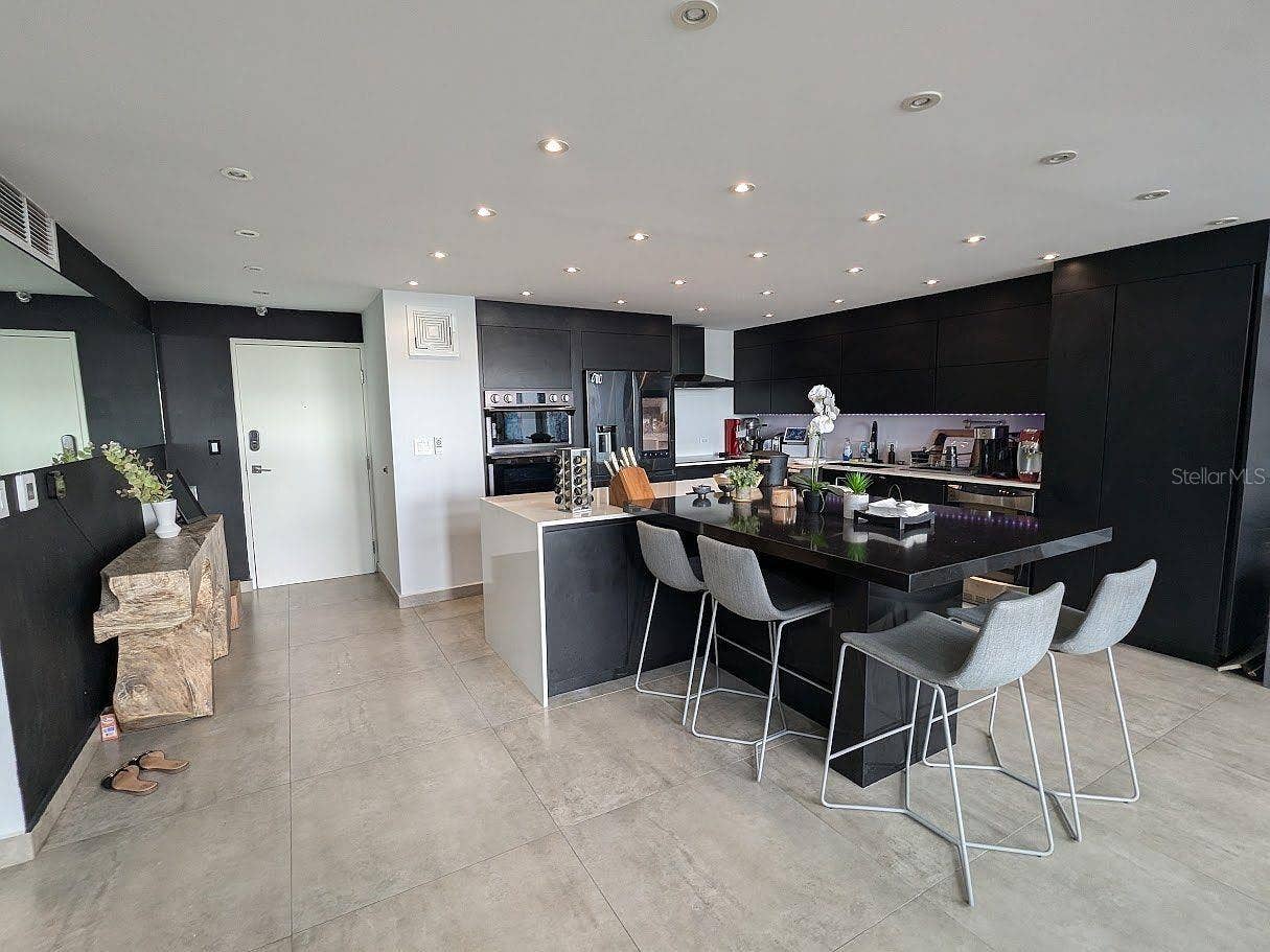 305 CALLE VILLAMIL, #PH 2001, San Juan, PR 00907 Kitchen black cabinetry and large island