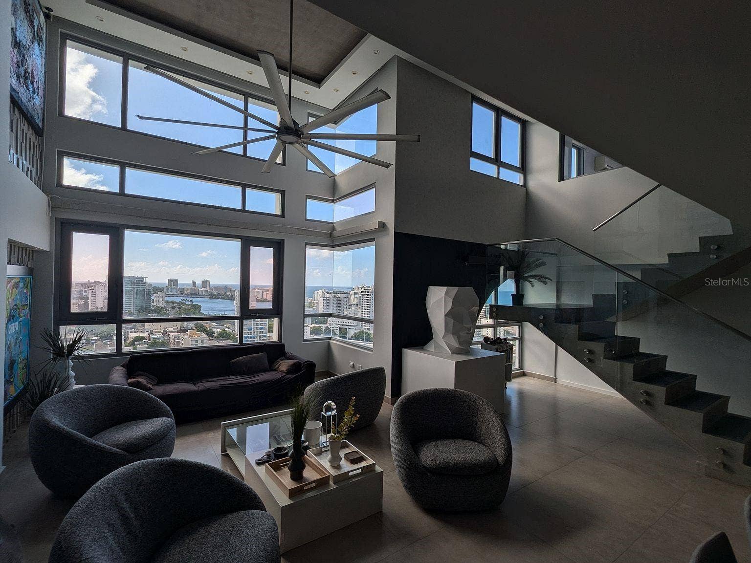 305 CALLE VILLAMIL, #PH 2001, San Juan, PR 00907 Living room double-height windows with lagoon and ocean views