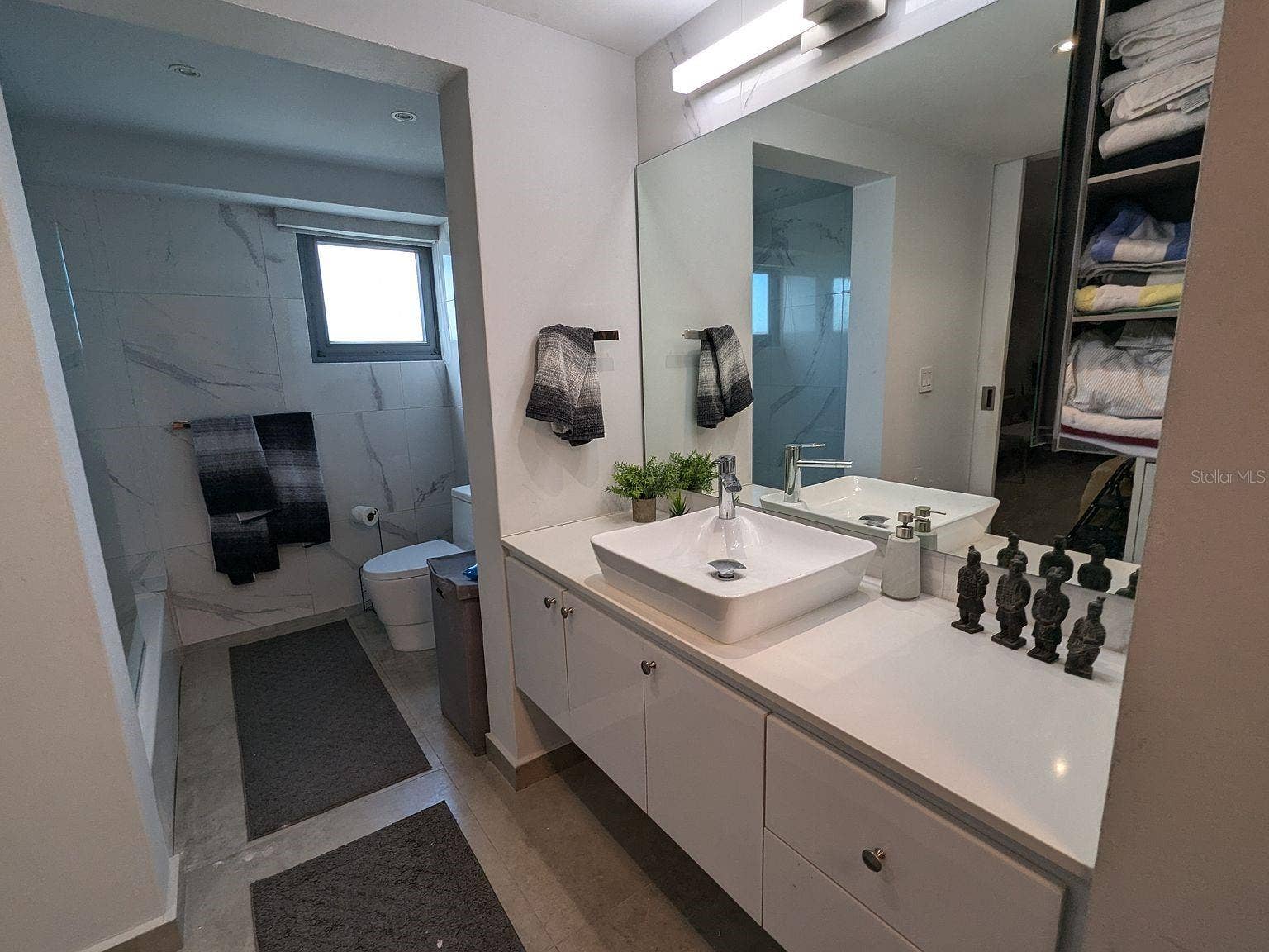 305 CALLE VILLAMIL, #PH 2001, San Juan, PR 00907 Bathroom marble-look tile and vessel-sink vanity