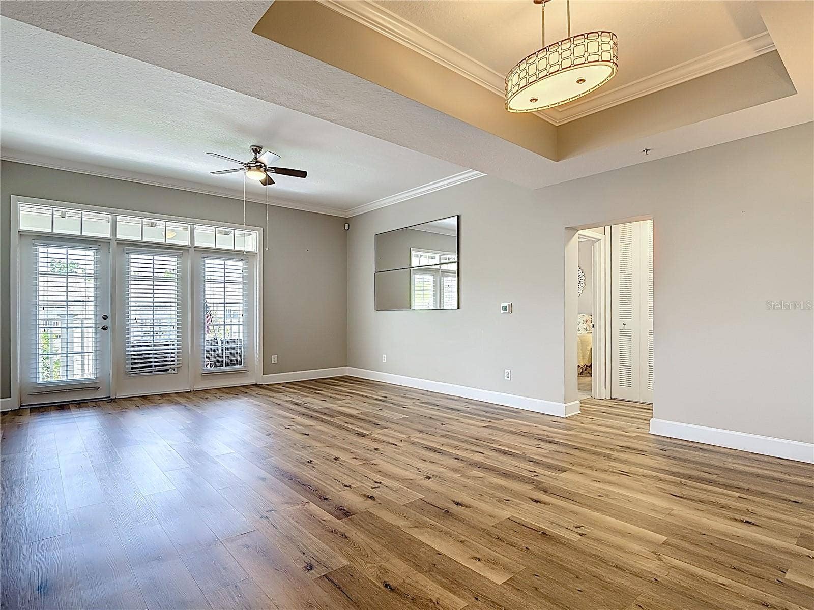 1231 WRIGHT CIR, #308, Celebration, FL 34747 Dining Room with Tray Ceiling and Living Room with French Door to Terrace