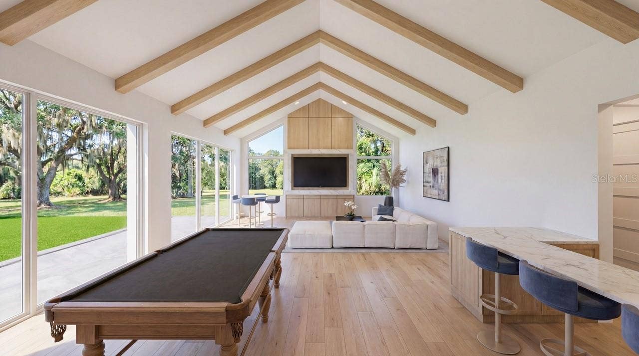 3654 HIDDEN RIVER LANE, Tavares, FL 32778 Vaulted beam ceiling in the recreation room that provides seamless lines with the pool and deck