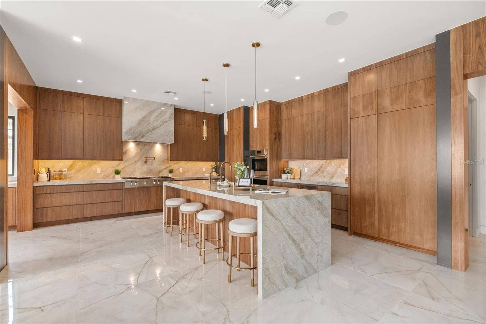 9117 BAY POINT DRIVE, Orlando, FL 32819 Kitchen has customised walnut cabinets and Taj Mahal counters