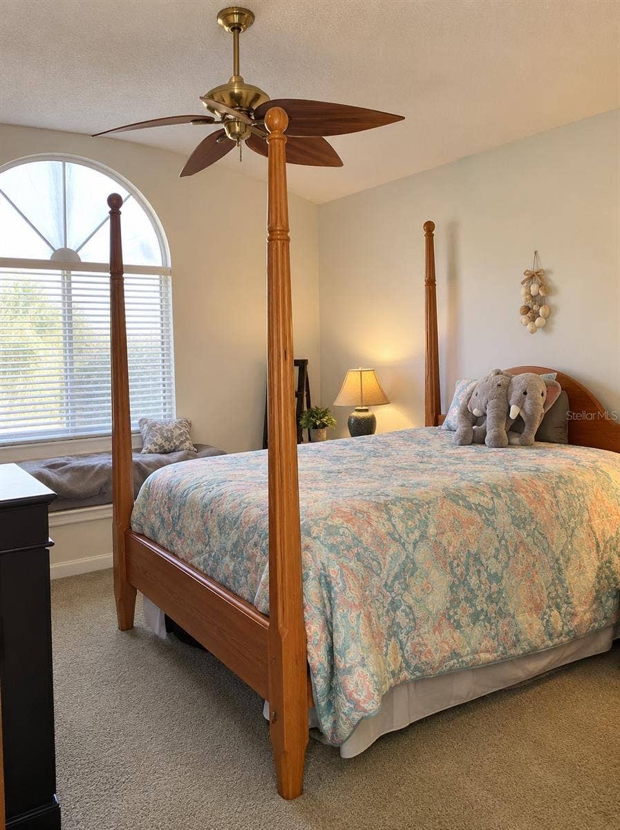 1061 ARAGON AVENUE, #1061, Winter Park, FL 32789 Primary bedroom with sitting area, ceiling fan and volume ceilings