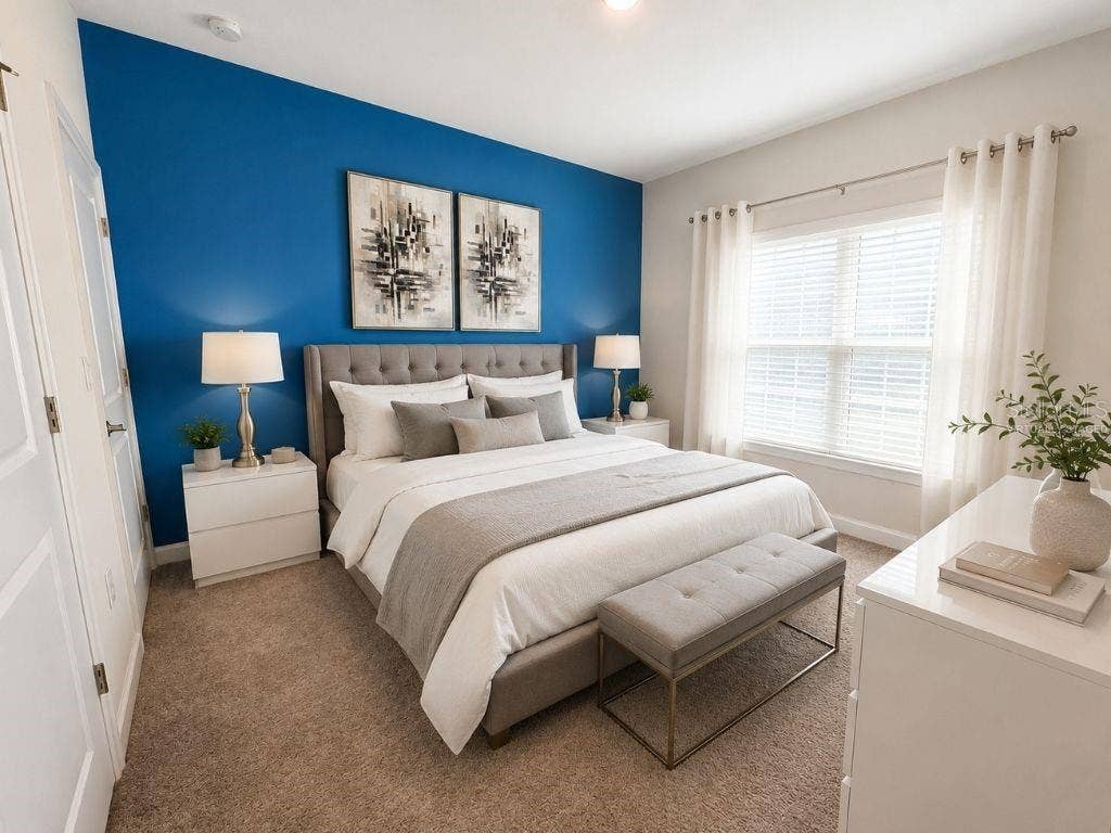 Virtually staged downstairs bedroom highlighting a bright, comfortable layout with modern neutral decor and a bold accent wall.