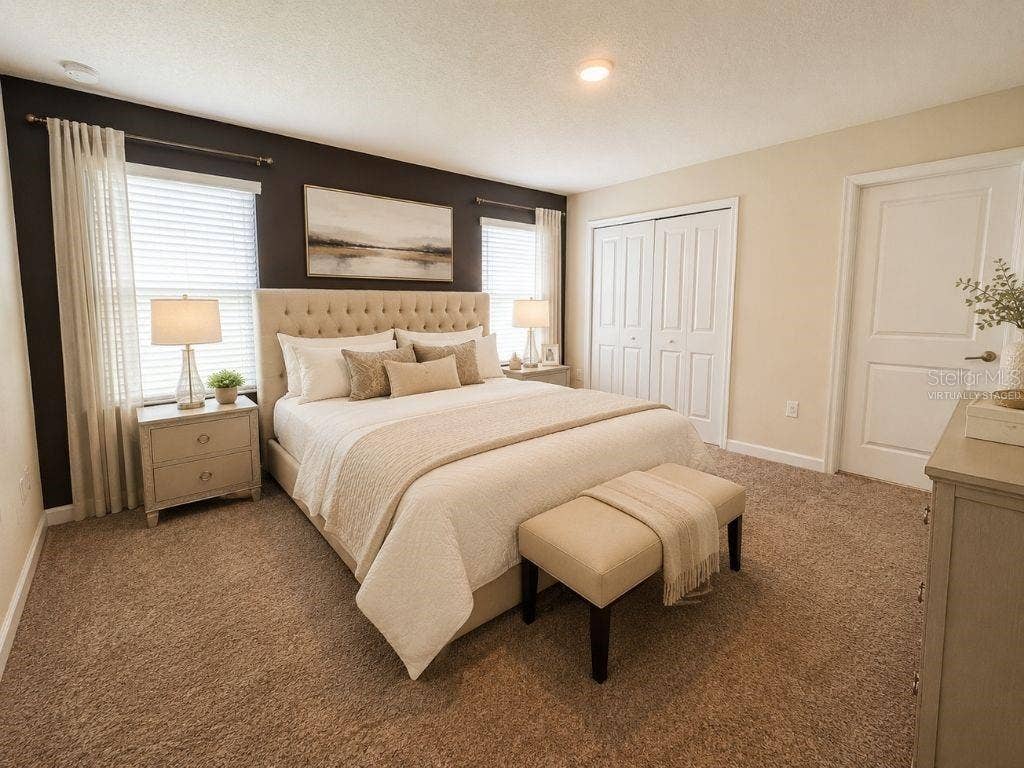 Virtually staged primary bedroom highlighting a spacious, comfortable retreat with neutral finishes, soft natural light, and a relaxing resort-style feel.