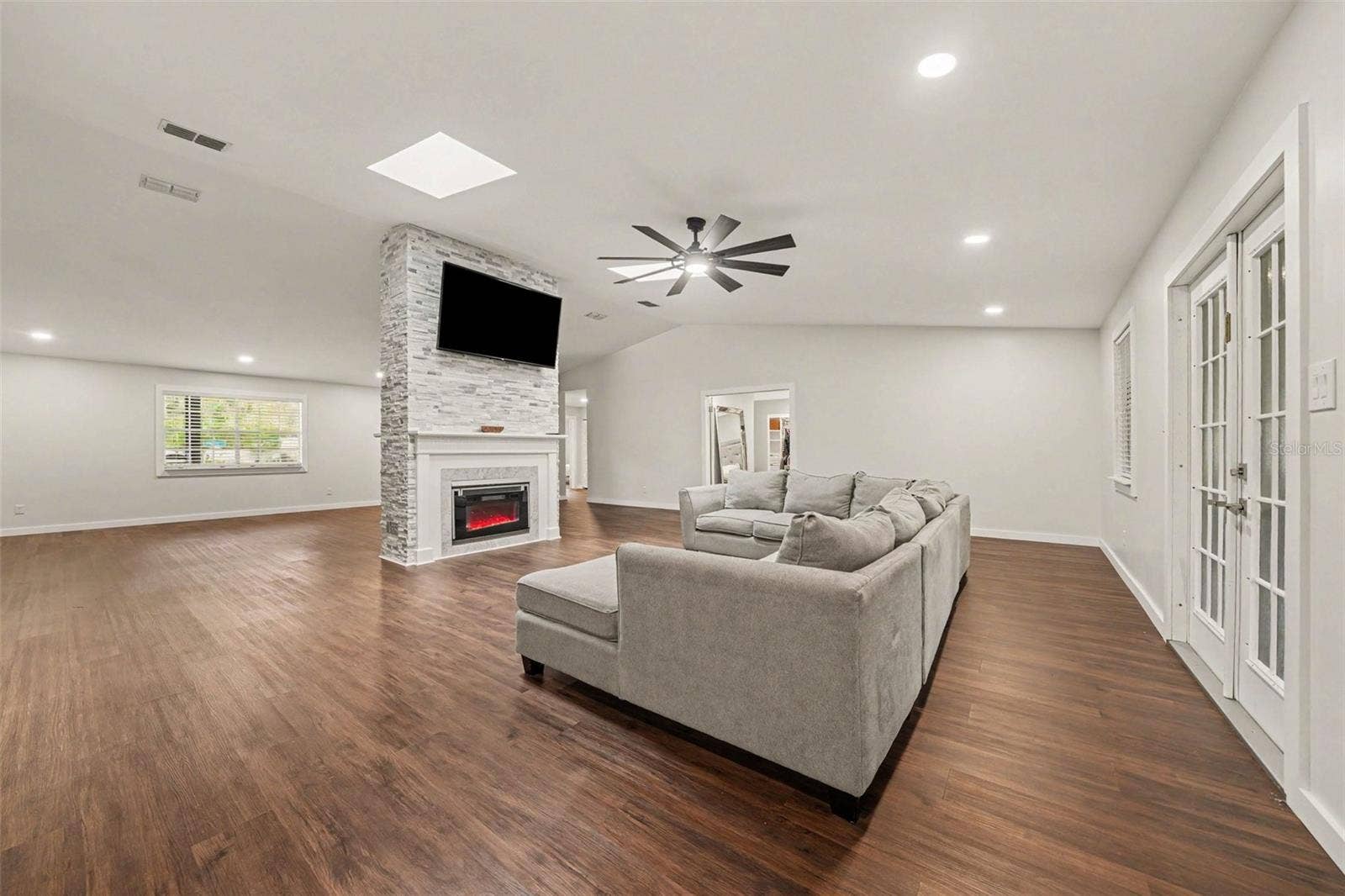 1592 SKYLINE DRIVE, Kissimmee, FL 34744 Family Room w/ Electric Fireplace, TV & stone accent wall