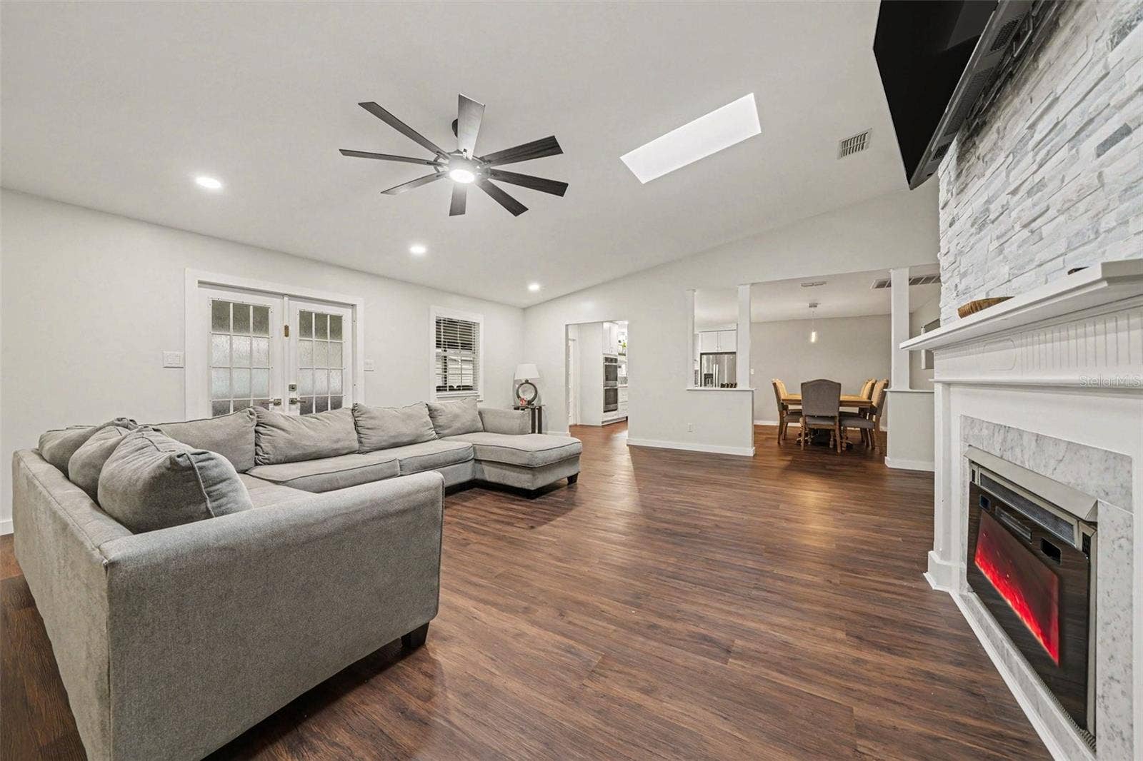 1592 SKYLINE DRIVE, Kissimmee, FL 34744 Spacious Family Room featuring Electric Fireplace & Stone tile accent wall