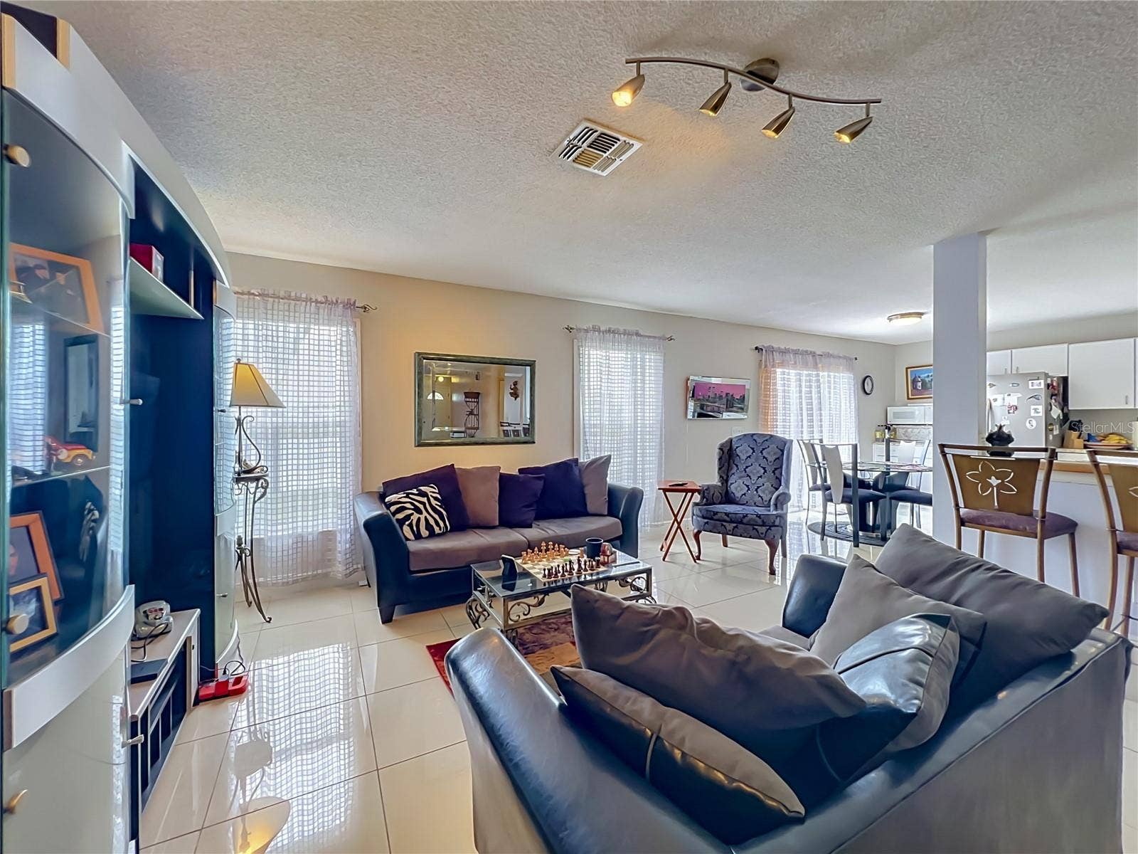 12900 LOS ALAMITOS COURT, Orlando, FL 32837 Family room, with dinette area to kitchen