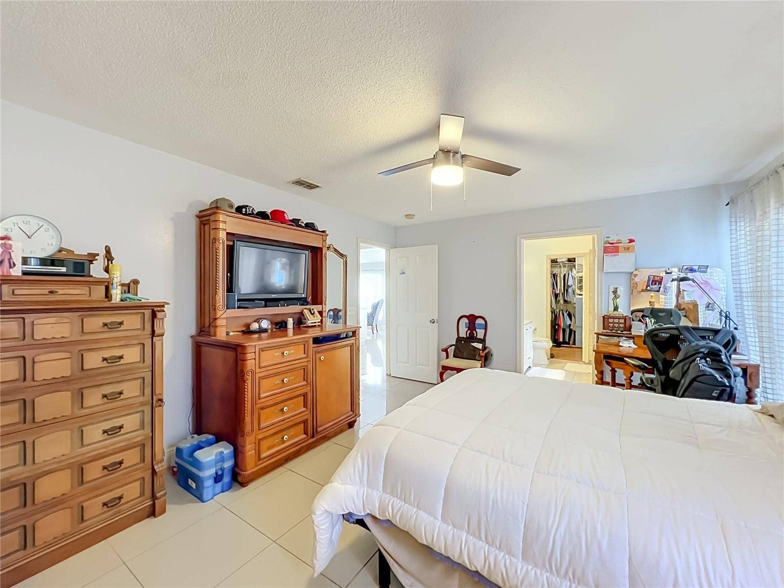 12900 LOS ALAMITOS COURT, Orlando, FL 32837 Primary bedroom on 1st floor with ceiling fan and ceramic tile floor