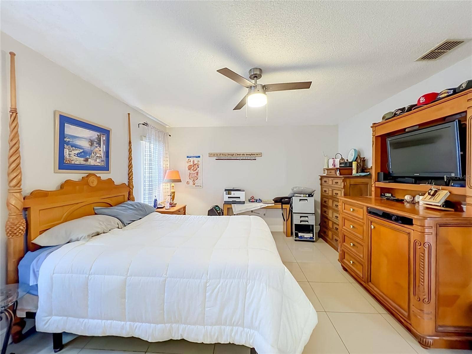 12900 LOS ALAMITOS COURT, Orlando, FL 32837 Primary bedroom on 1st floor with ceiling fan and ceramic tile floor