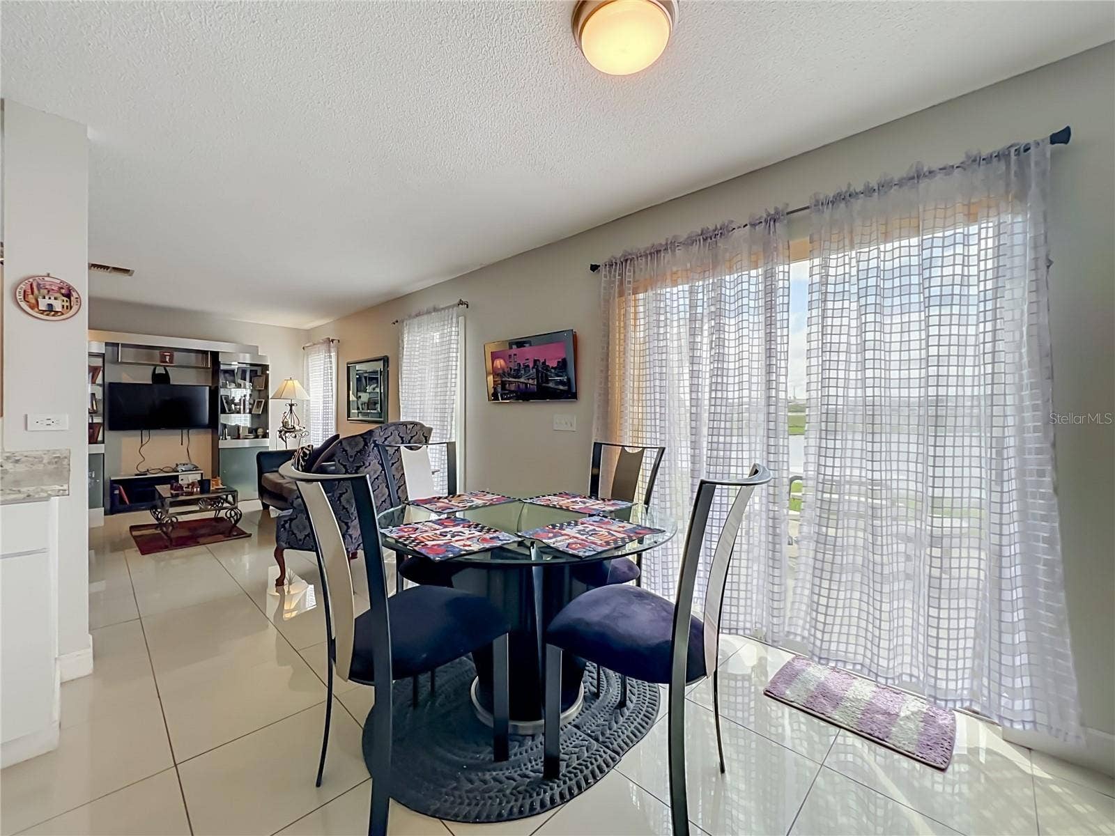 12900 LOS ALAMITOS COURT, Orlando, FL 32837 Dinette area with sliding doors to the back yard and pond front