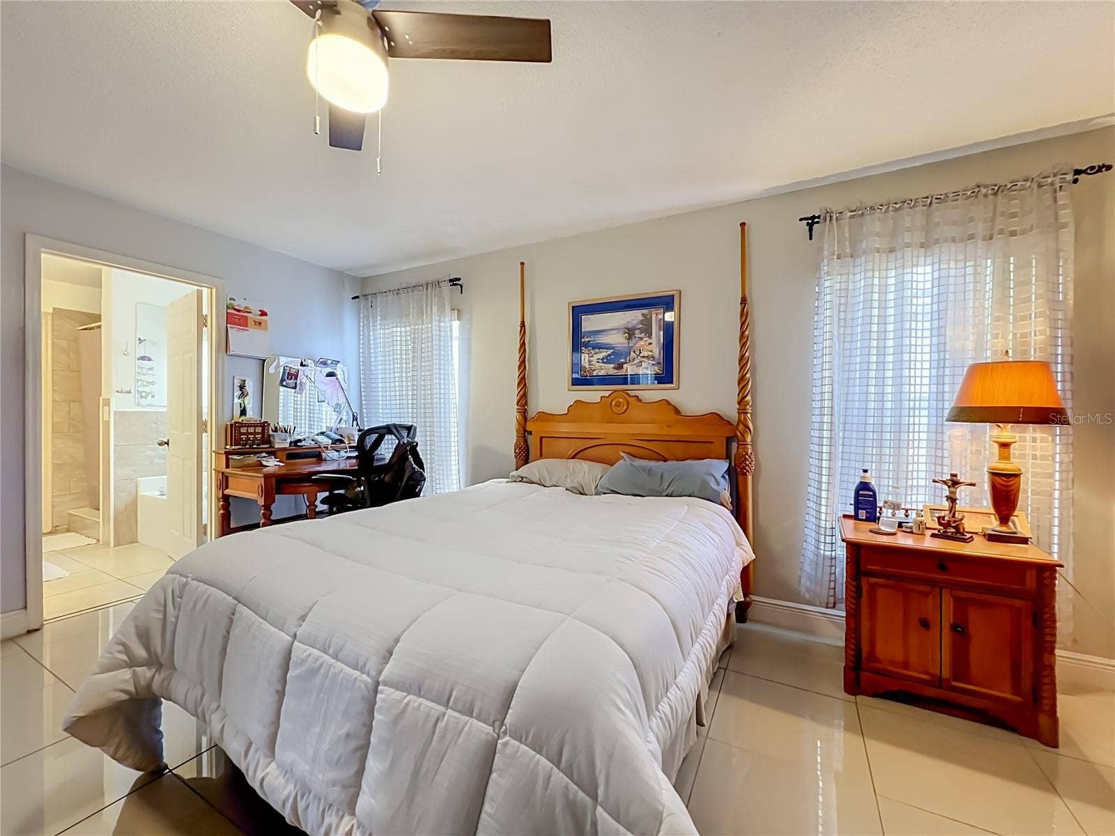 12900 LOS ALAMITOS COURT, Orlando, FL 32837 Primary bedroom on 1st floor with ceiling fan and ceramic tile floor