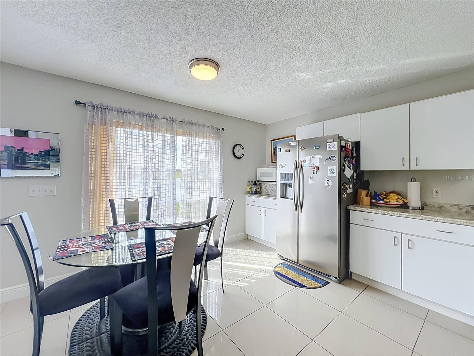 12900 LOS ALAMITOS COURT, Orlando, FL 32837 Dinette area in kitchen with sliding doors to the back yard and pond front