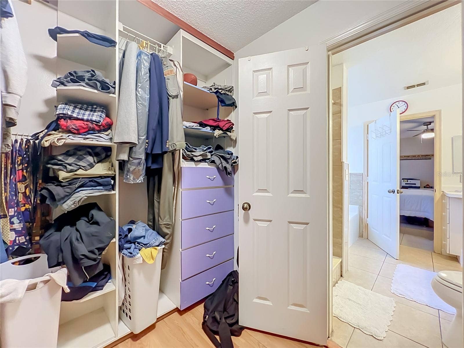 12900 LOS ALAMITOS COURT, Orlando, FL 32837 Wood floors and built in drawers and shelving in the large Primary walk in closet