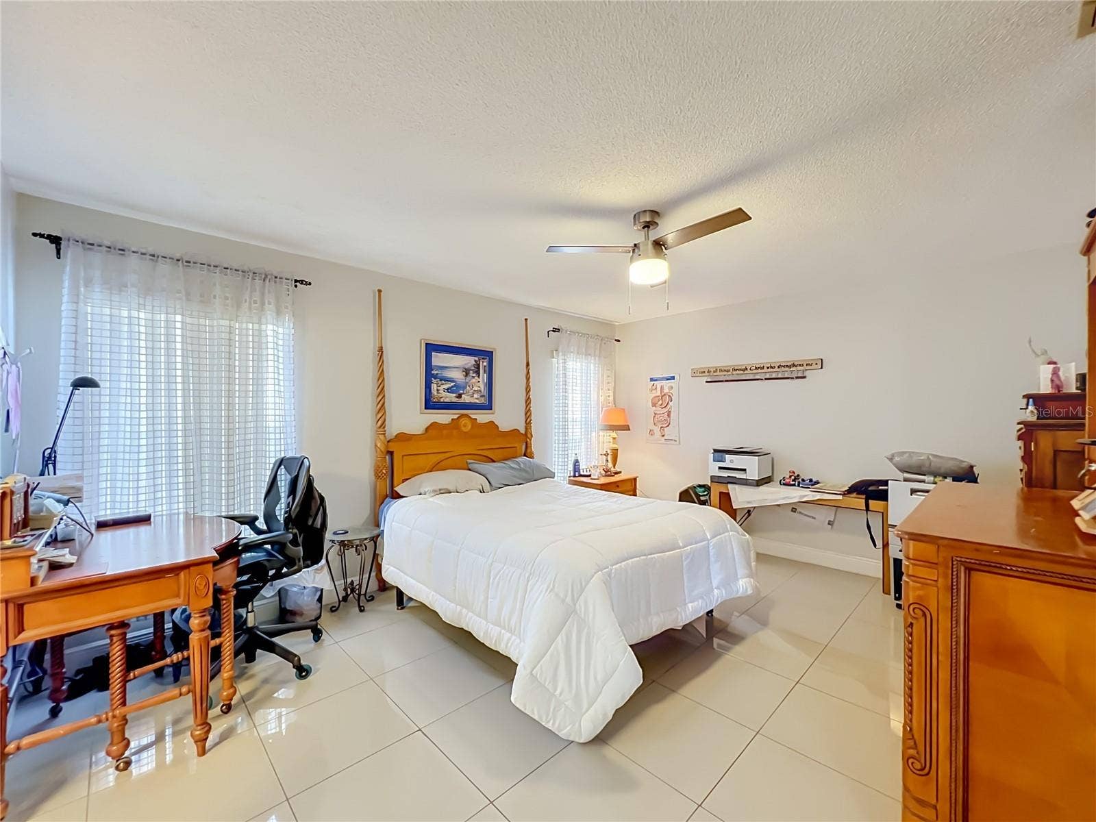 12900 LOS ALAMITOS COURT, Orlando, FL 32837 Primary bedroom on 1st floor with ceiling fan and ceramic tile floor