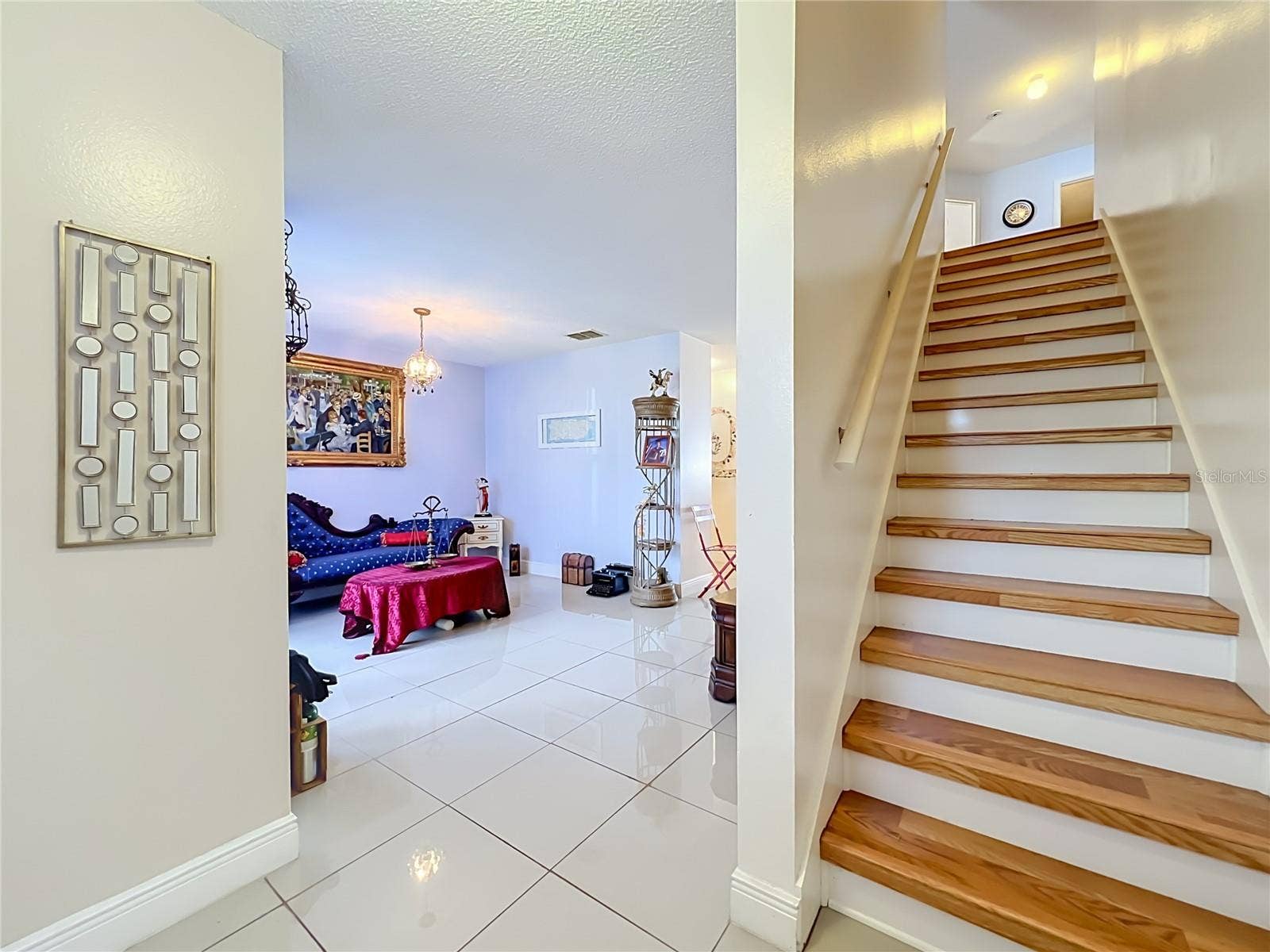 12900 LOS ALAMITOS COURT, Orlando, FL 32837 First floor is all ceramic tile, and wood leads to upstairs where all floors are wood laminate