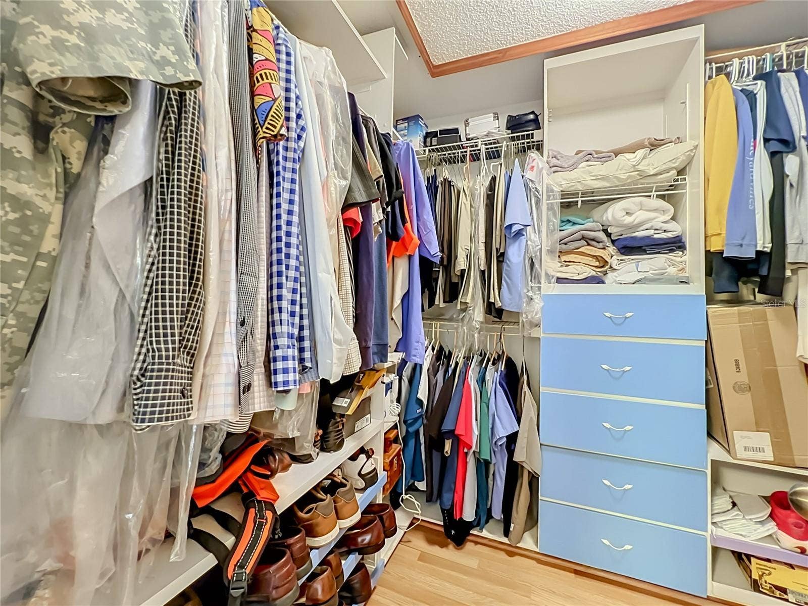 12900 LOS ALAMITOS COURT, Orlando, FL 32837 Wood floors and built in drawers and shelving in the large walk in Primary closet