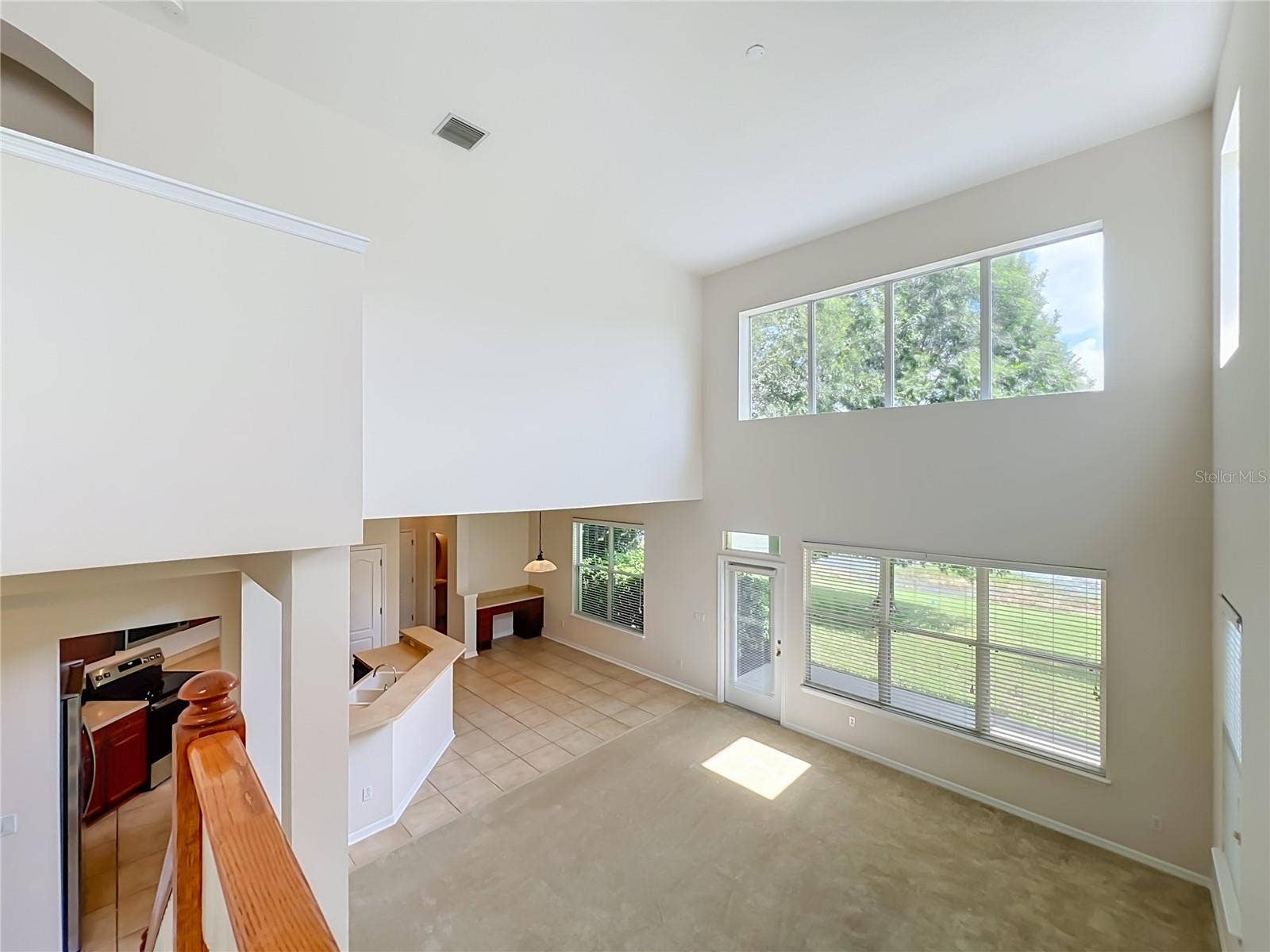 12809 HOLDENBURY LANE, Windermere, FL 34786 Family living area features lots of light from high ceilings and 2-story windows! Dinette area includes built-in desk, Kitchen features breakfast bar, New appliances, wood cabinets, and closet pantry