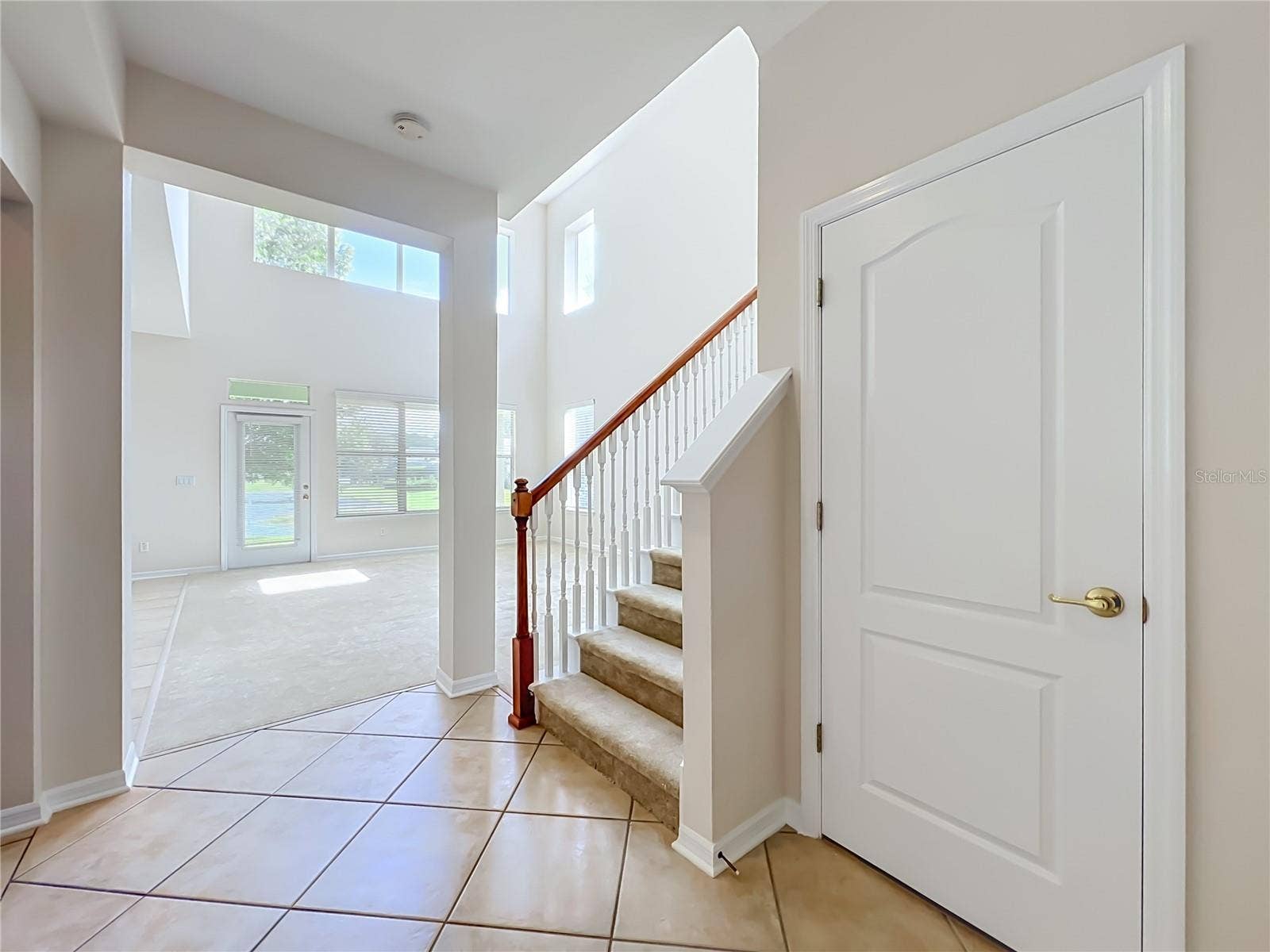 12809 HOLDENBURY LANE, Windermere, FL 34786 Hall closet and carpeted stairway in the center of the home