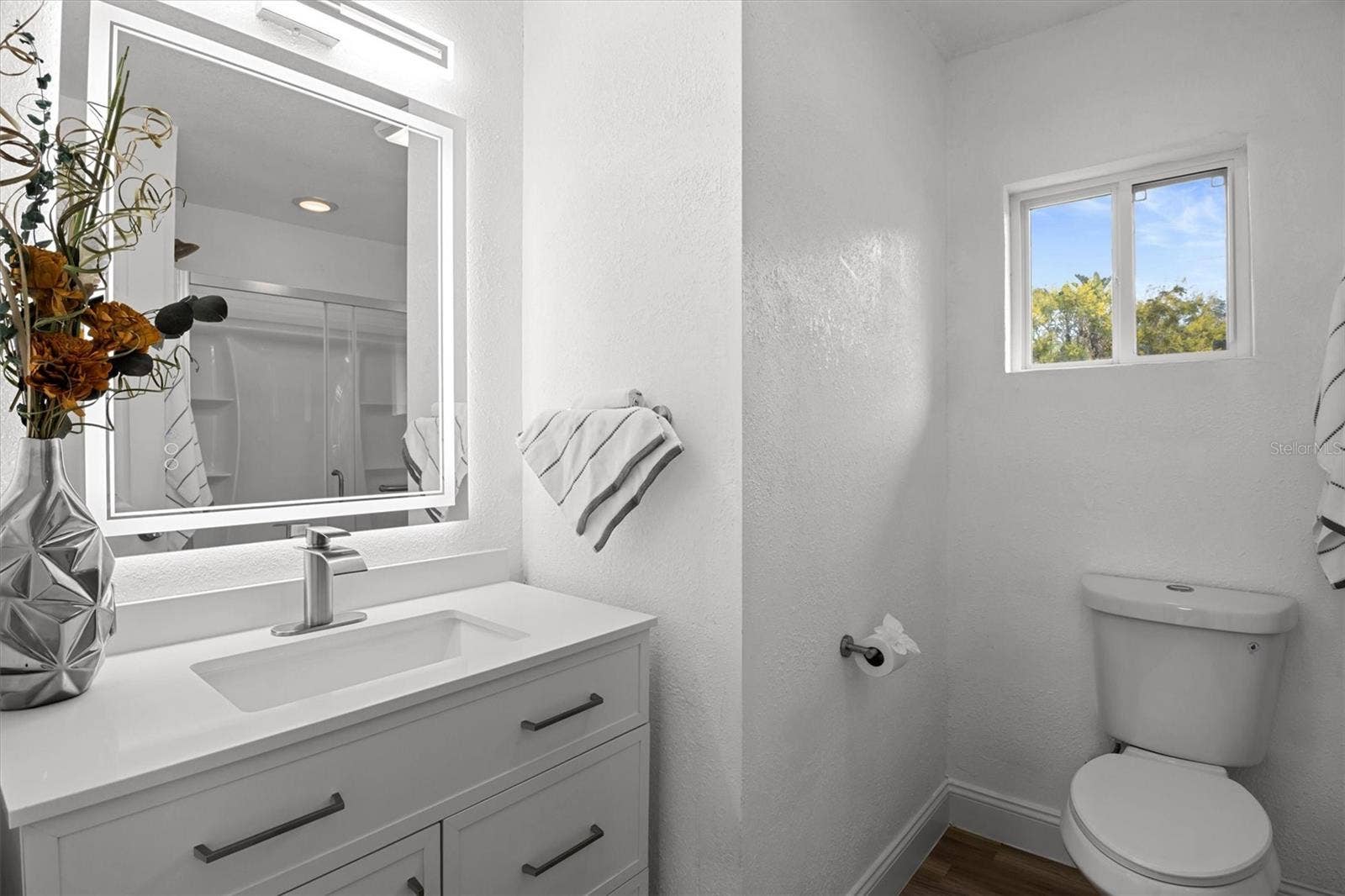 Primary Bathroom - Stone Countertops & Lighted Mirror