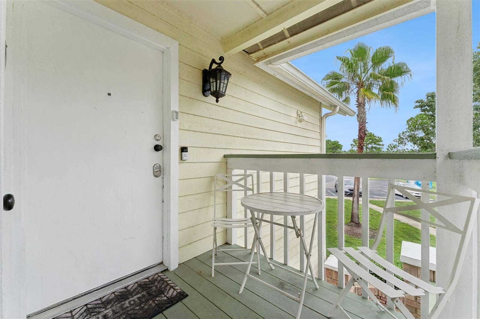 5017 LAGUNA BAY CIRCLE, #100, Kissimmee, FL 34746 Private Porch Entry: Secluded covered entry balcony with room for small patio seating and views of the community grounds
