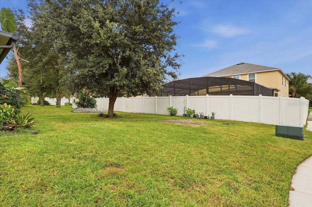 Large backyard with shaded with an oak tree