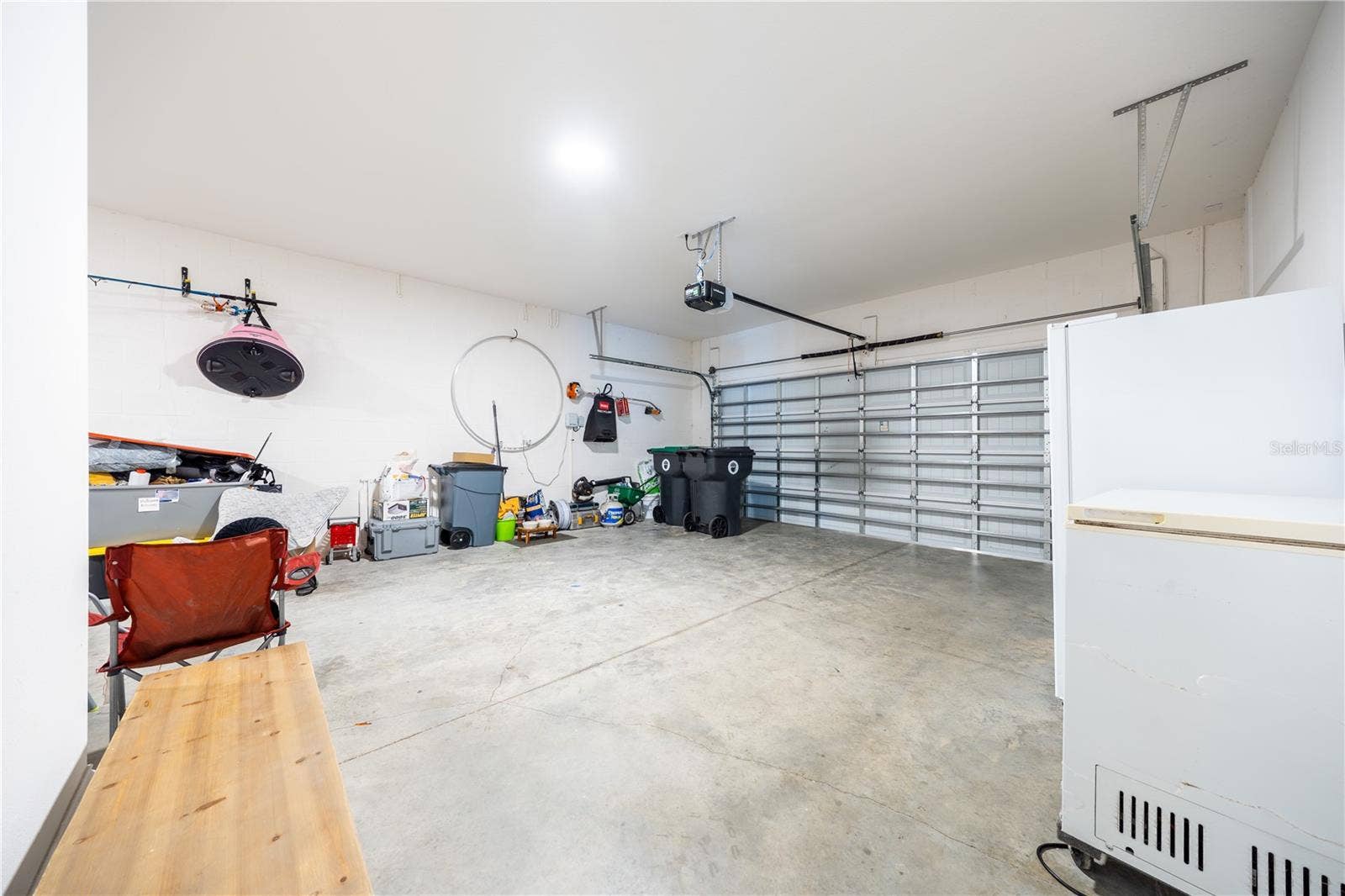 1316 SOUTHERN SUN DRIVE, Oakland, FL 34787 Spacious two-car garage with an automatic door opener and room for additional storage.