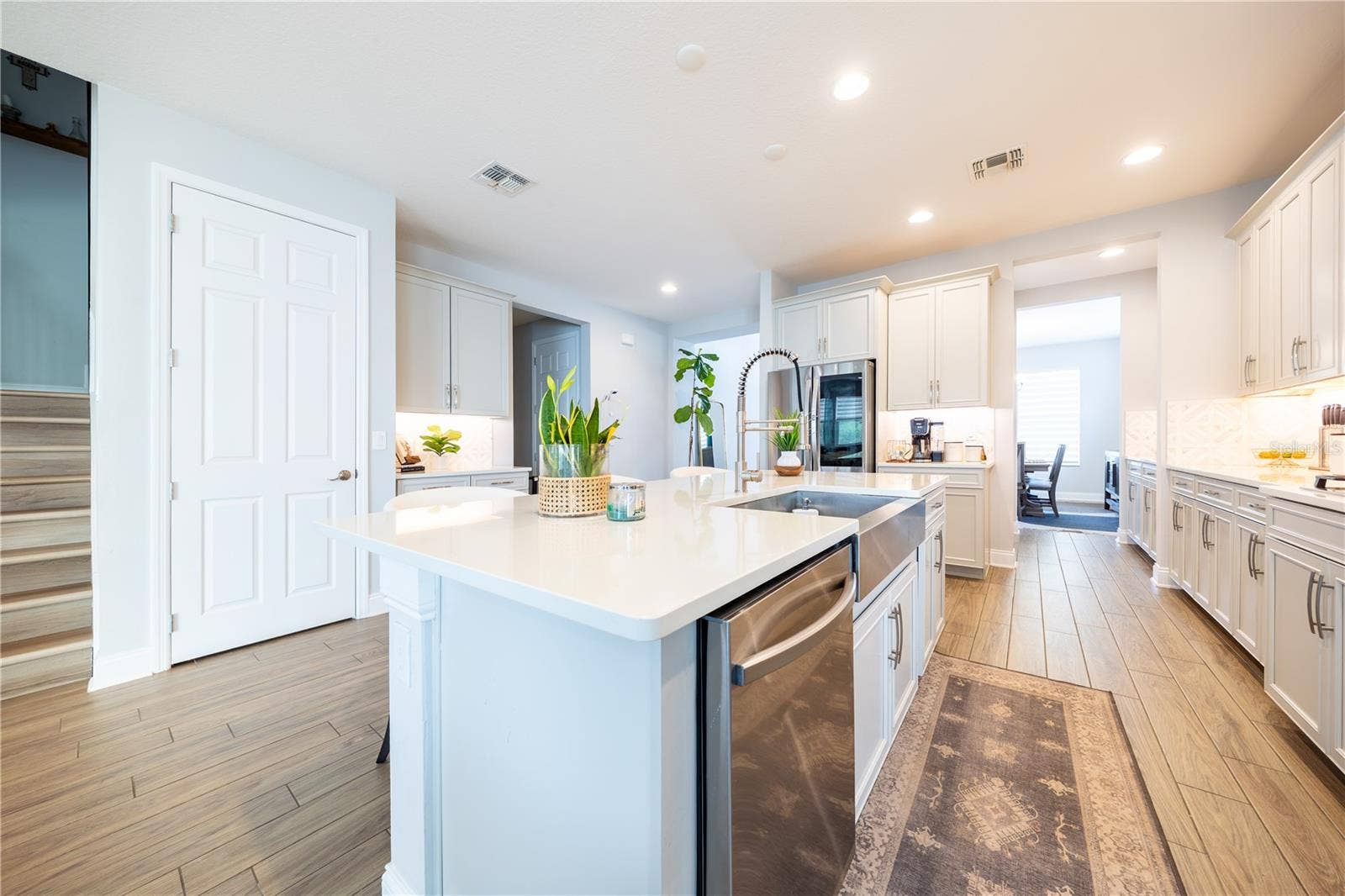 1316 SOUTHERN SUN DRIVE, Oakland, FL 34787 Spacious kitchen island featuring a stainless steel apron-front sink, pull-down faucet, and integrated dishwasher.