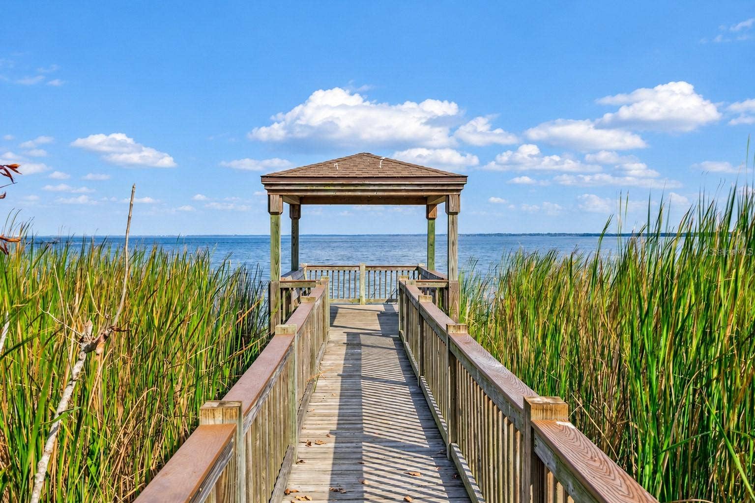 1316 SOUTHERN SUN DRIVE, Oakland, FL 34787 Community boardwalk leading to a covered lakeside gazebo with sweeping water views.