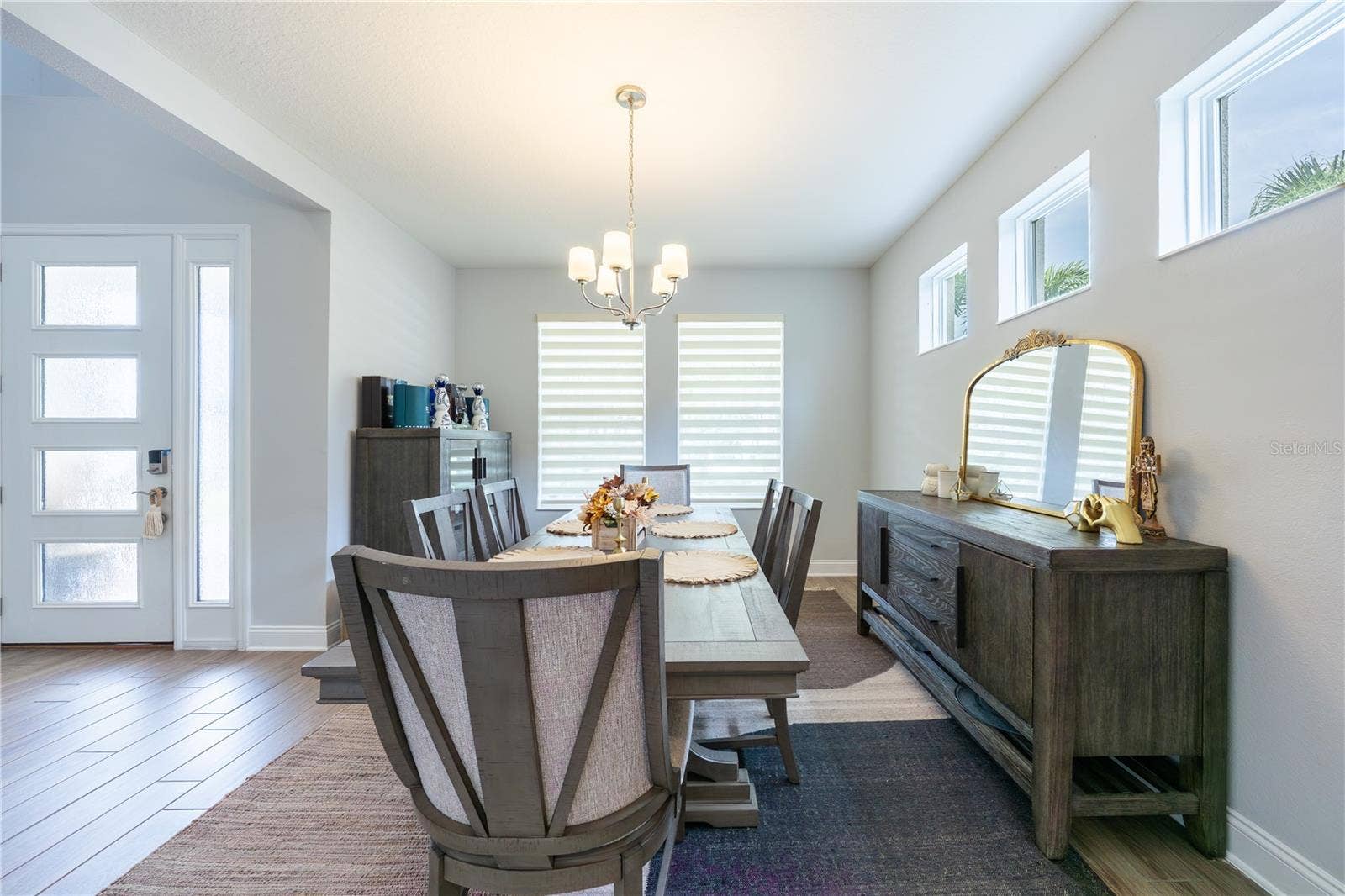 1316 SOUTHERN SUN DRIVE, Oakland, FL 34787 Elegant dining room with high windows and a classic chandelier, just off the foyer.