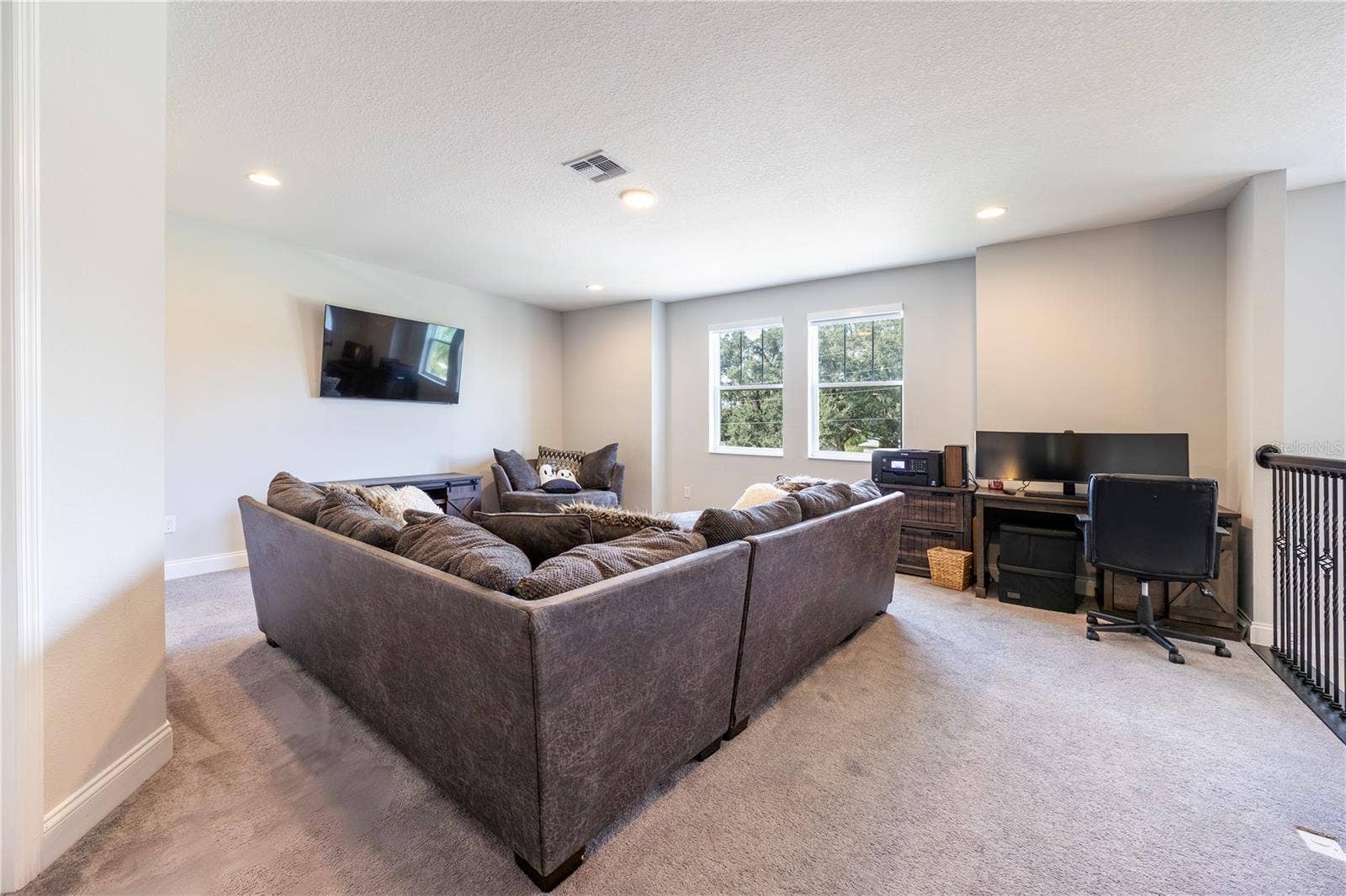 1316 SOUTHERN SUN DRIVE, Oakland, FL 34787 Versatile upstairs loft with spacious seating and a home office area overlooking the trees.