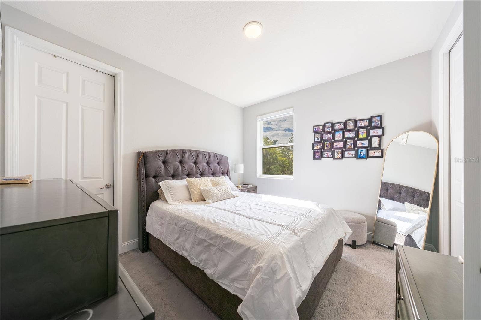 1316 SOUTHERN SUN DRIVE, Oakland, FL 34787 Inviting bedroom with soft carpeting, neutral tones, and a double-door closet.