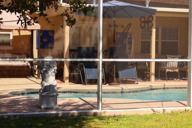 Pool and screened Porch view from the back