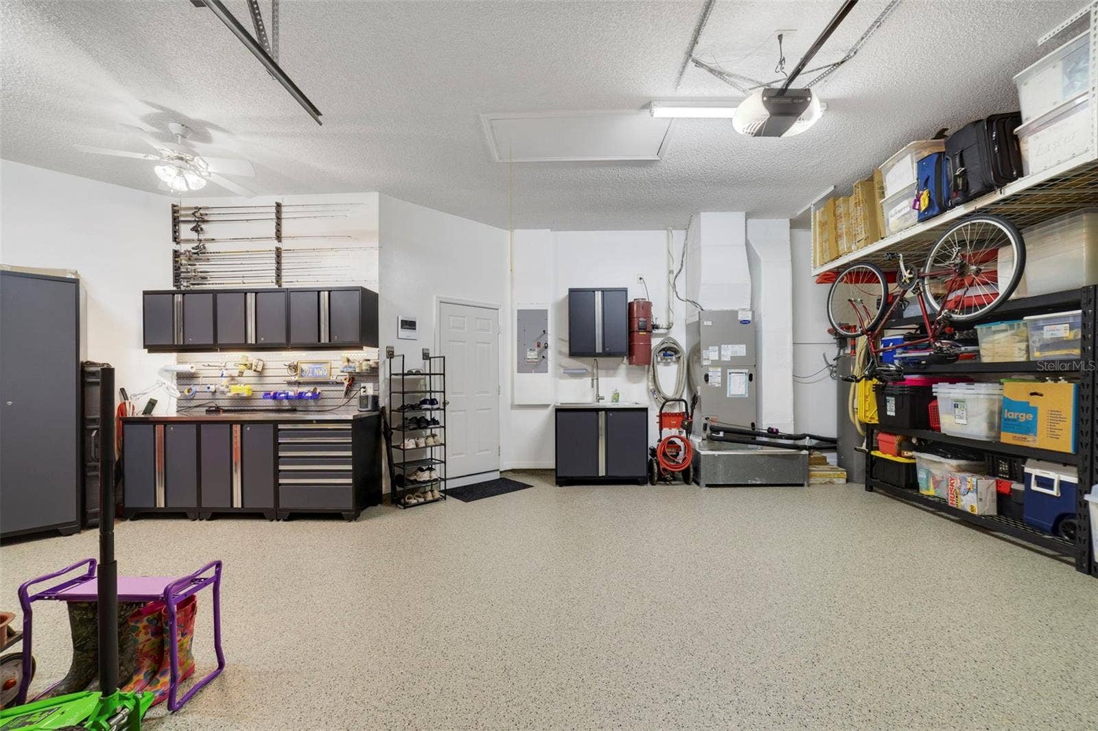 3514 OCITA DRIVE, Orlando, FL 32837 Another view of this magnificent garage space with custom workshop and storage shelves