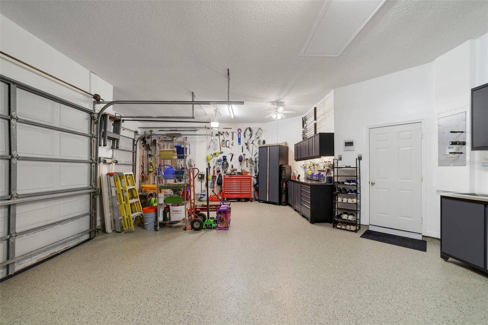 3514 OCITA DRIVE, Orlando, FL 32837 Immaculate garage with tech floor finish/S/S Cabinets, plenty of storage !!