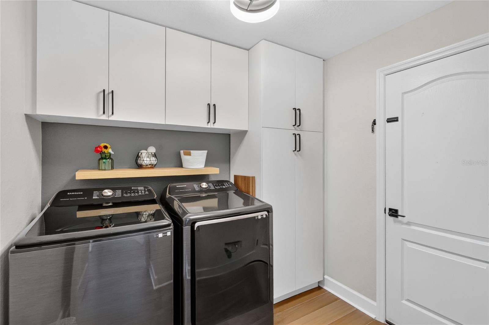 Laundry room with lots of cabinet space the owners added.