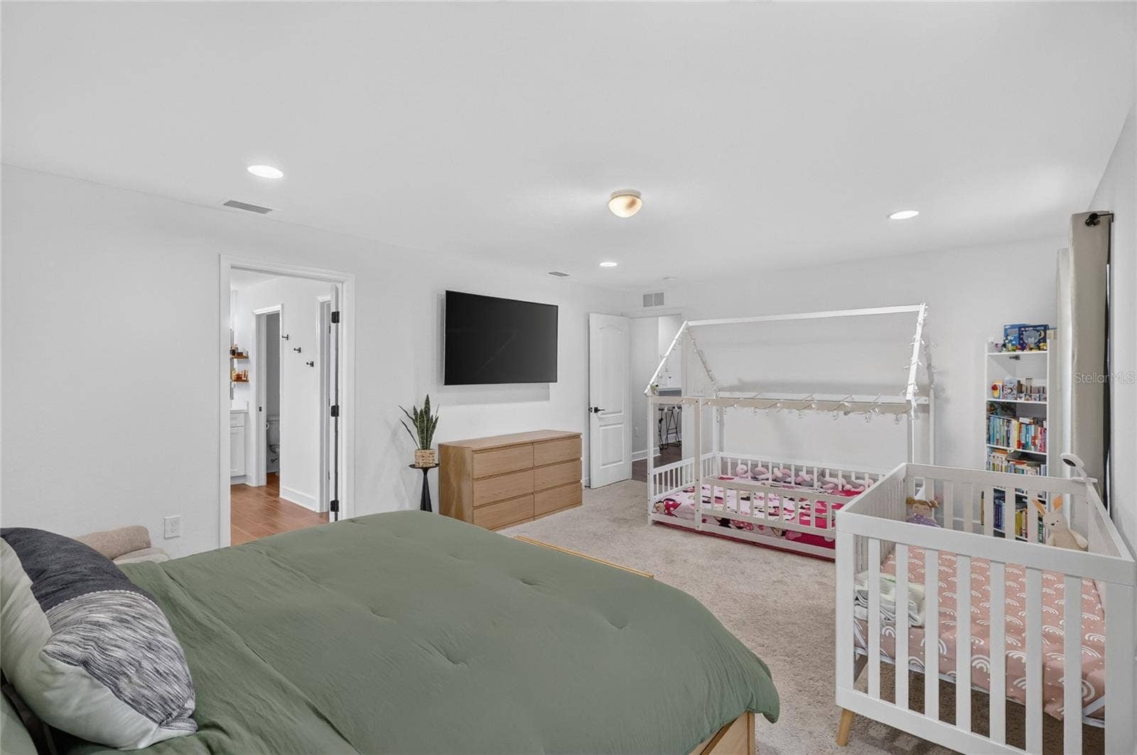 Room for a king size bed, toddler bed and crib in the primary bedroom