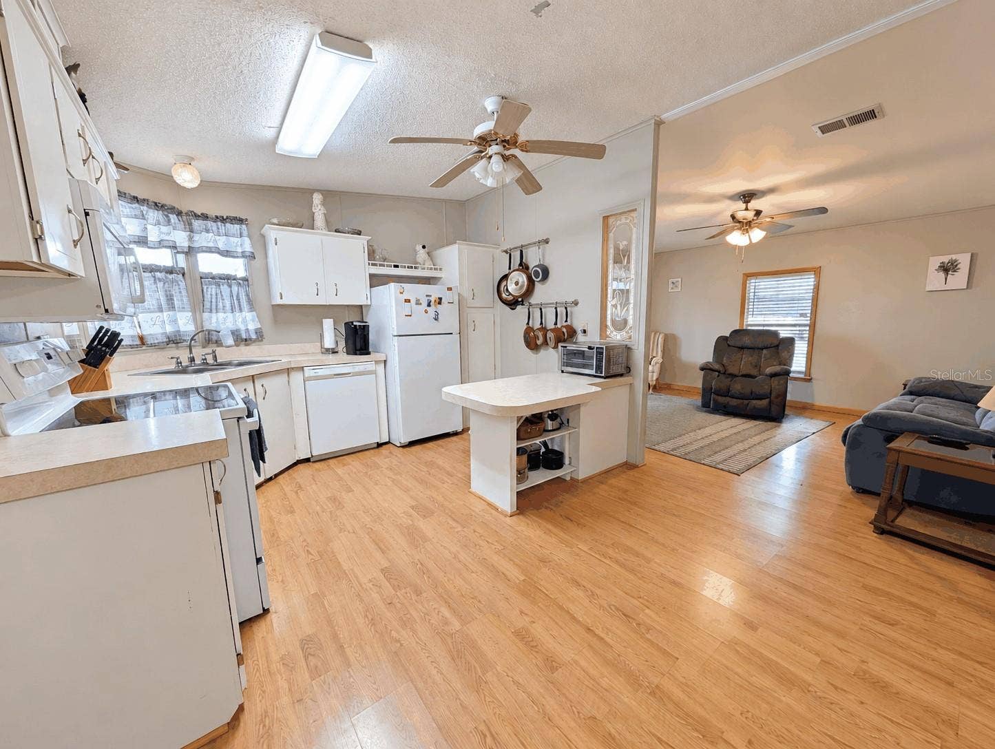 6066 SE SOUTHERN OAKS DRIVE, Winter Haven, FL 33884 Kitchen and Living Room view from Dining Room