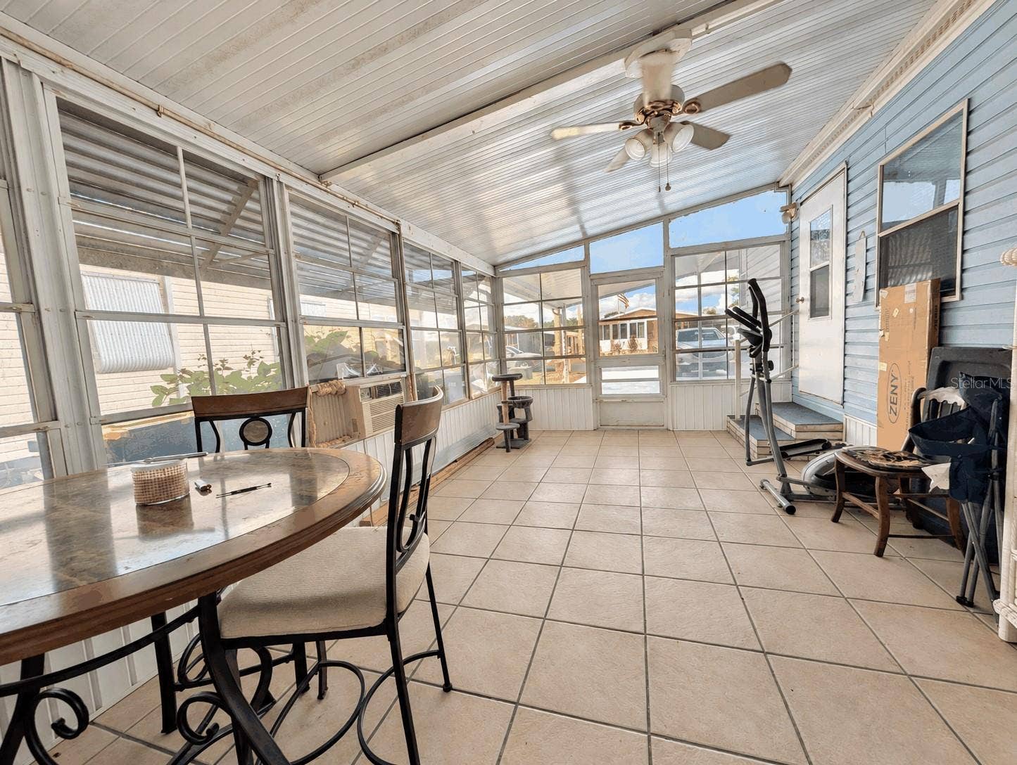 6066 SE SOUTHERN OAKS DRIVE, Winter Haven, FL 33884 Side screened porch view from back storage room