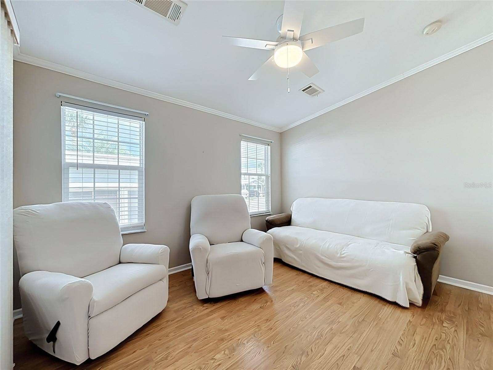 9000 US HIGHWAY 192, #181, Clermont, FL 34714 Living room provides easy access to elevated screen room with vinyl windows overlooking and providing access to the rear deck