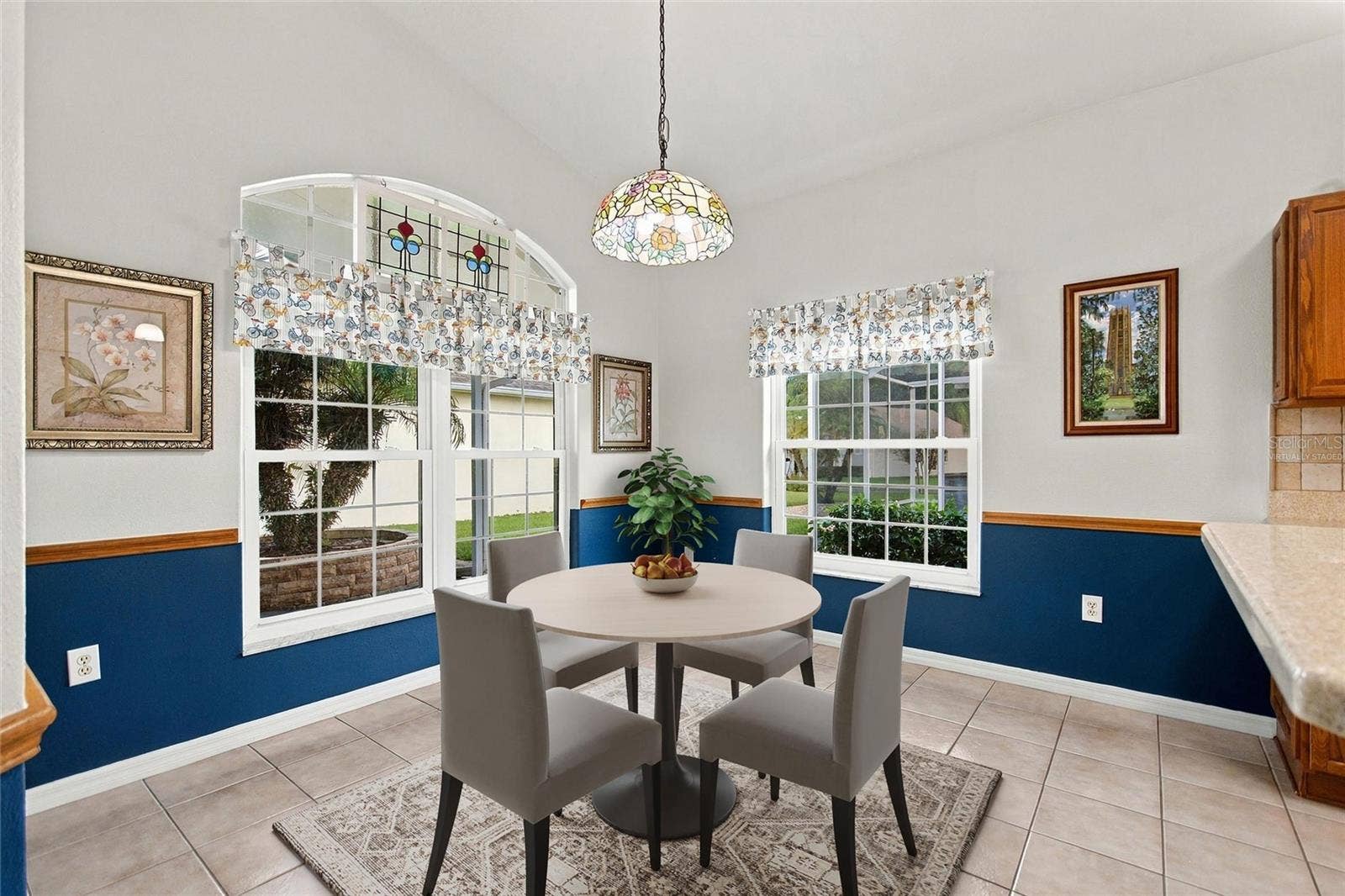 Virtually staged Kitchen eating area has vintage transom window