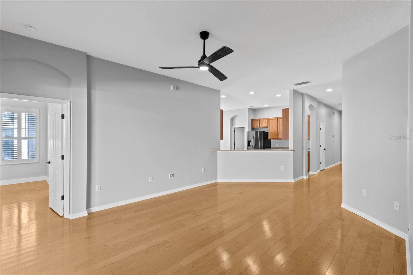3214 BAYFLOWER AVE, Harmony, FL 34773 Living area off kitchen leading to Primary bedroom