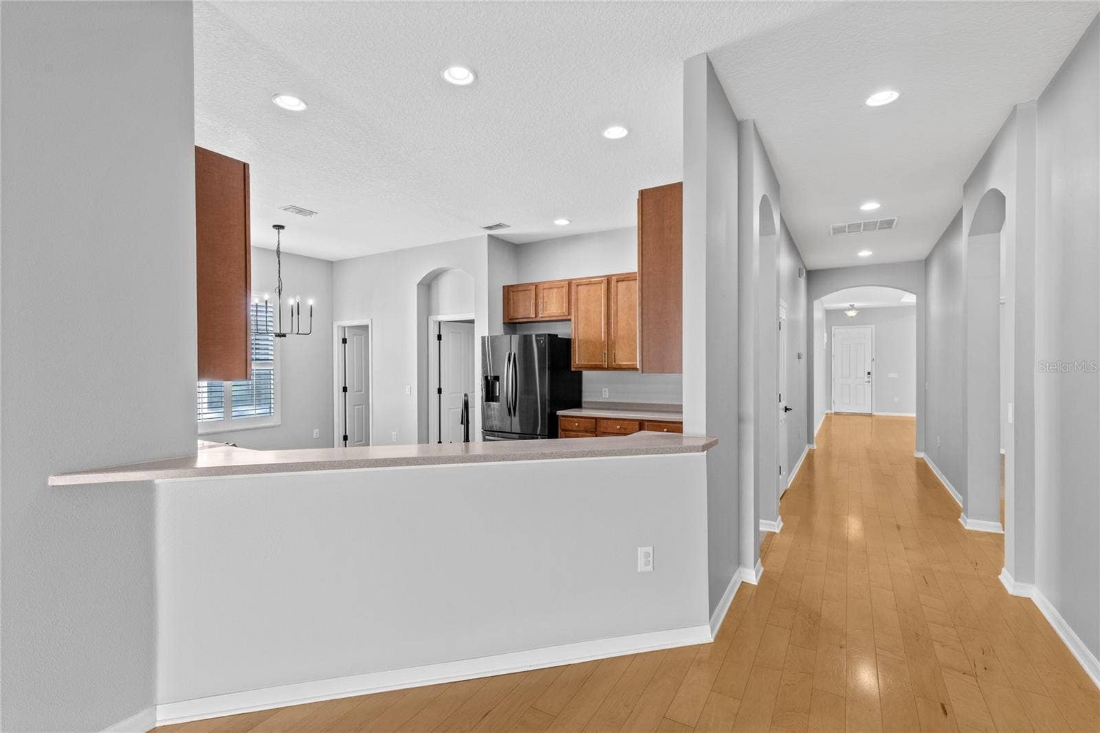 3214 BAYFLOWER AVE, Harmony, FL 34773 Hallway from front entry and flex room to kitchen