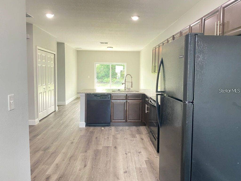 363 DUNDEE DRIVE, Poinciana, FL 34759 Original kitchen - rear living area view.