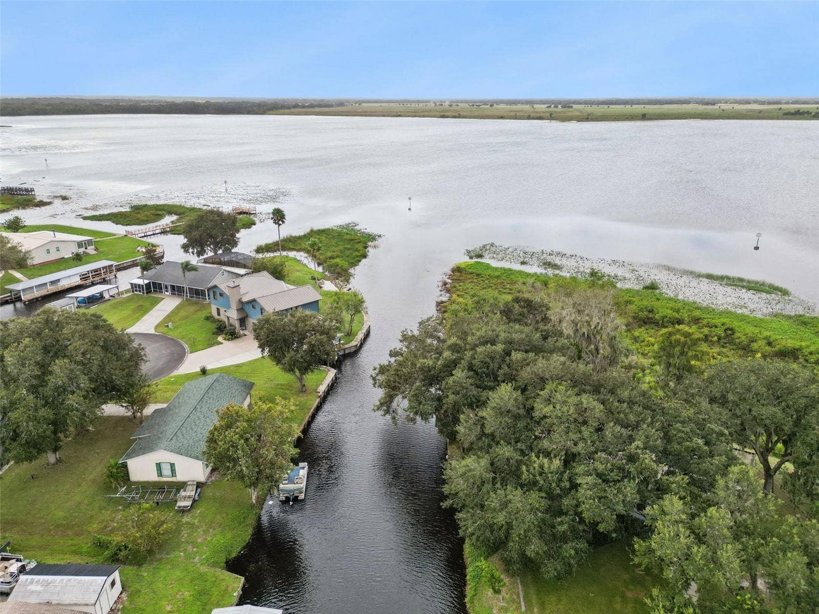 Aerial View of Canal Inlet: High-altitude photo capturing the mouth of the canal connecting directly into the open lake waters