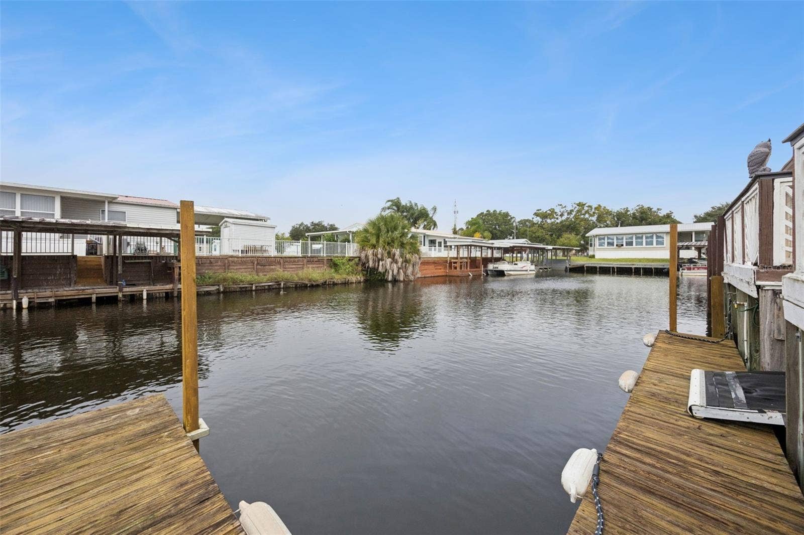 Canal Mooring Slip: Perspective of the private dock slip and canal frontage ideal for watercraft docking.